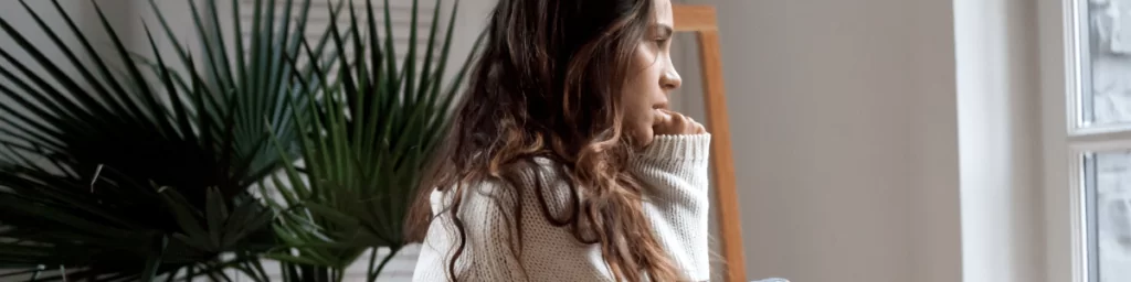 Woman with trauma looking at window