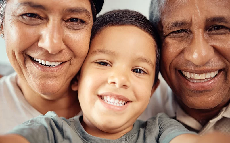 Trauma PTSD Therapy - Boy take selfie with happy grandparents