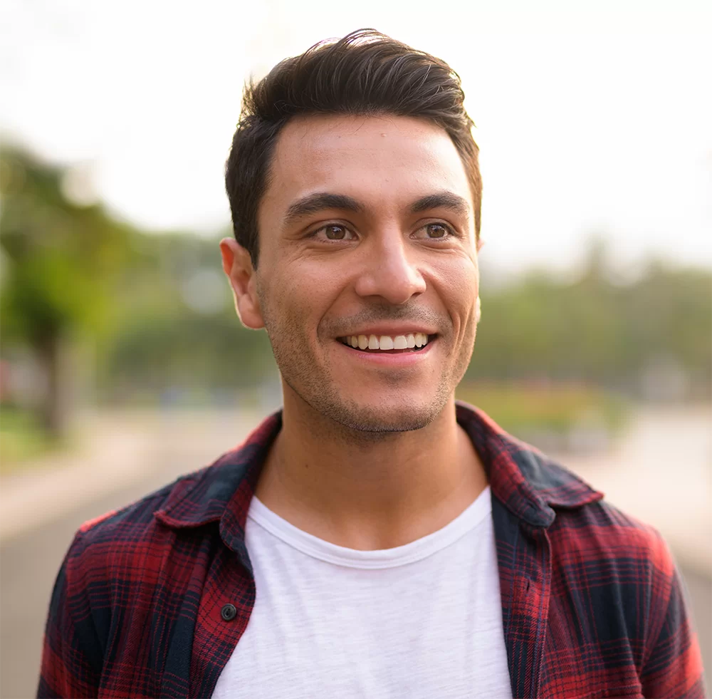 Face of happy young Hispanic