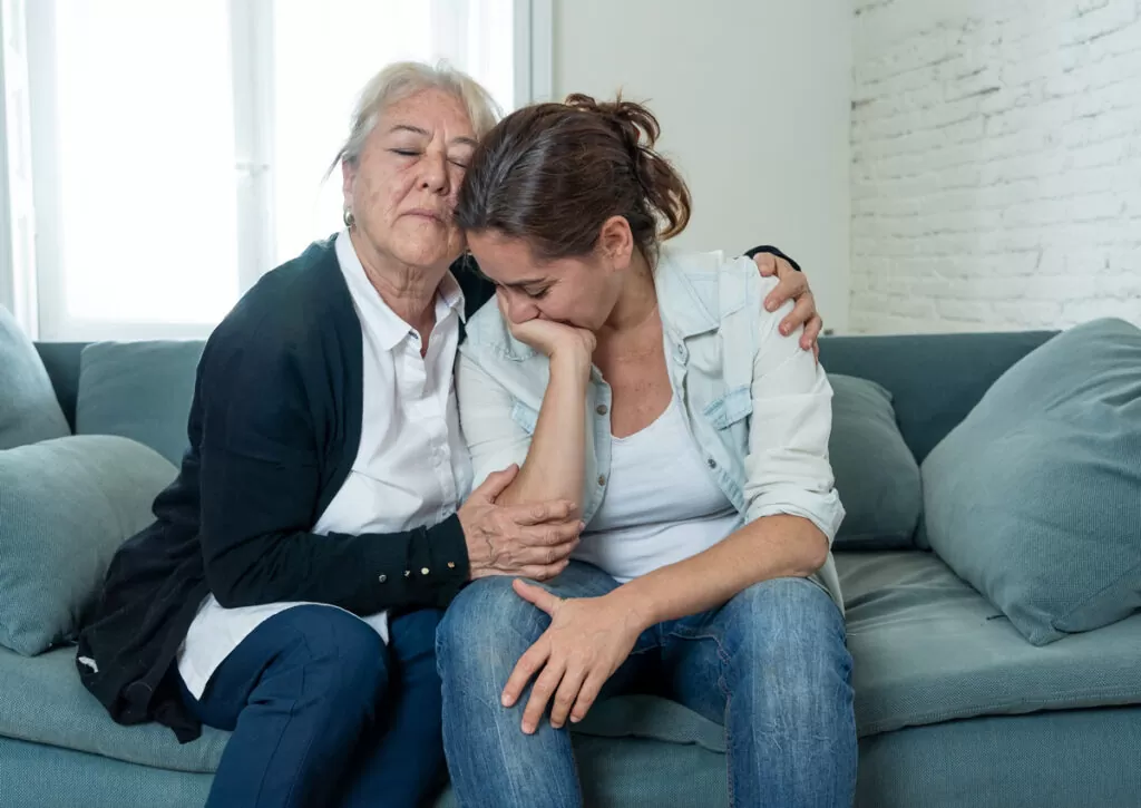 Two people hugging on a couch in Chicago.